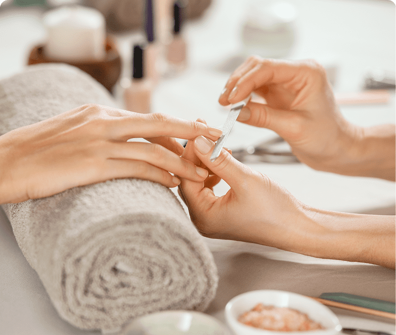 Hands receiving a manicure treatment