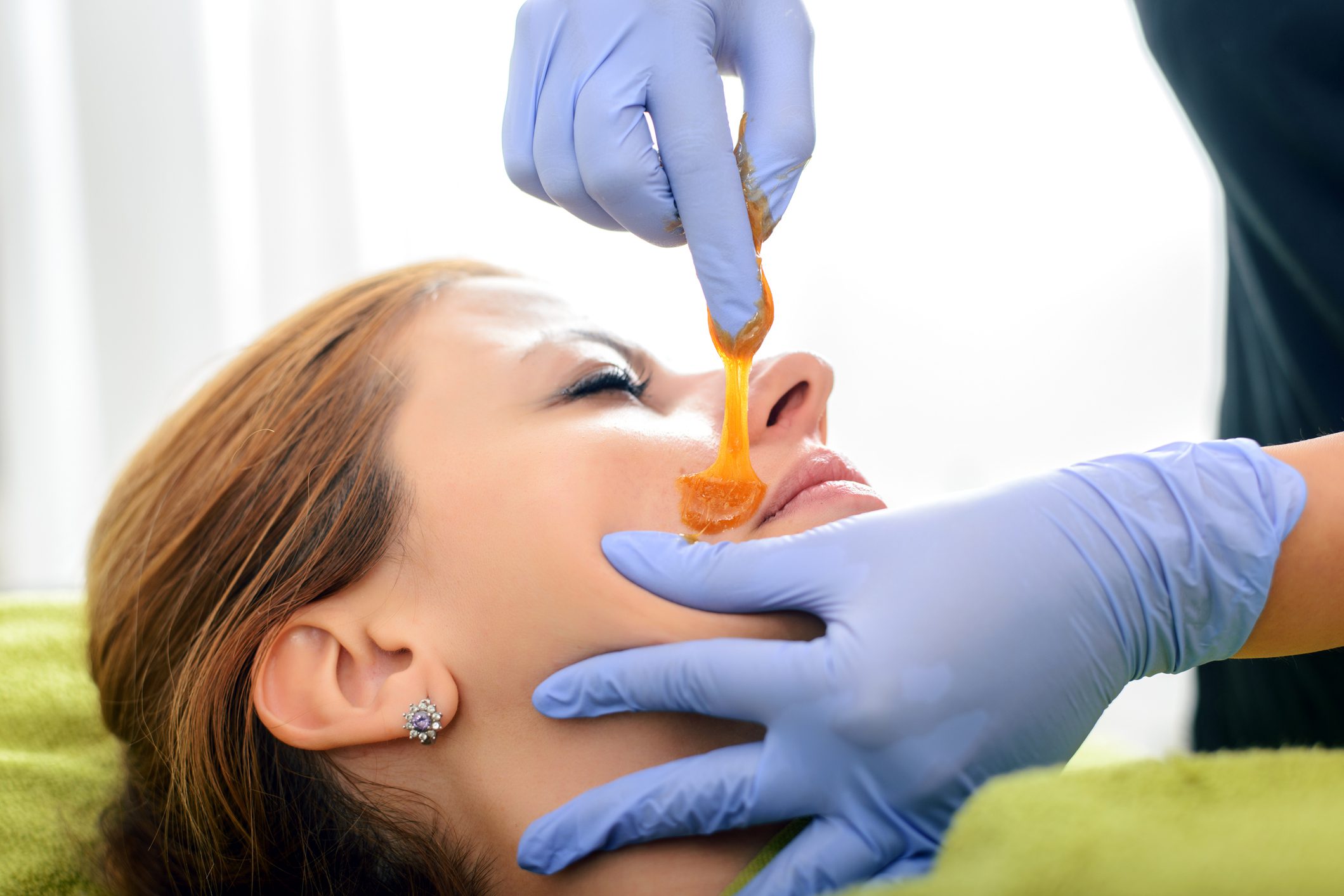 Woman facial reciving hair removal