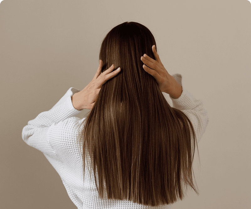 Back view of woman touching her hair
